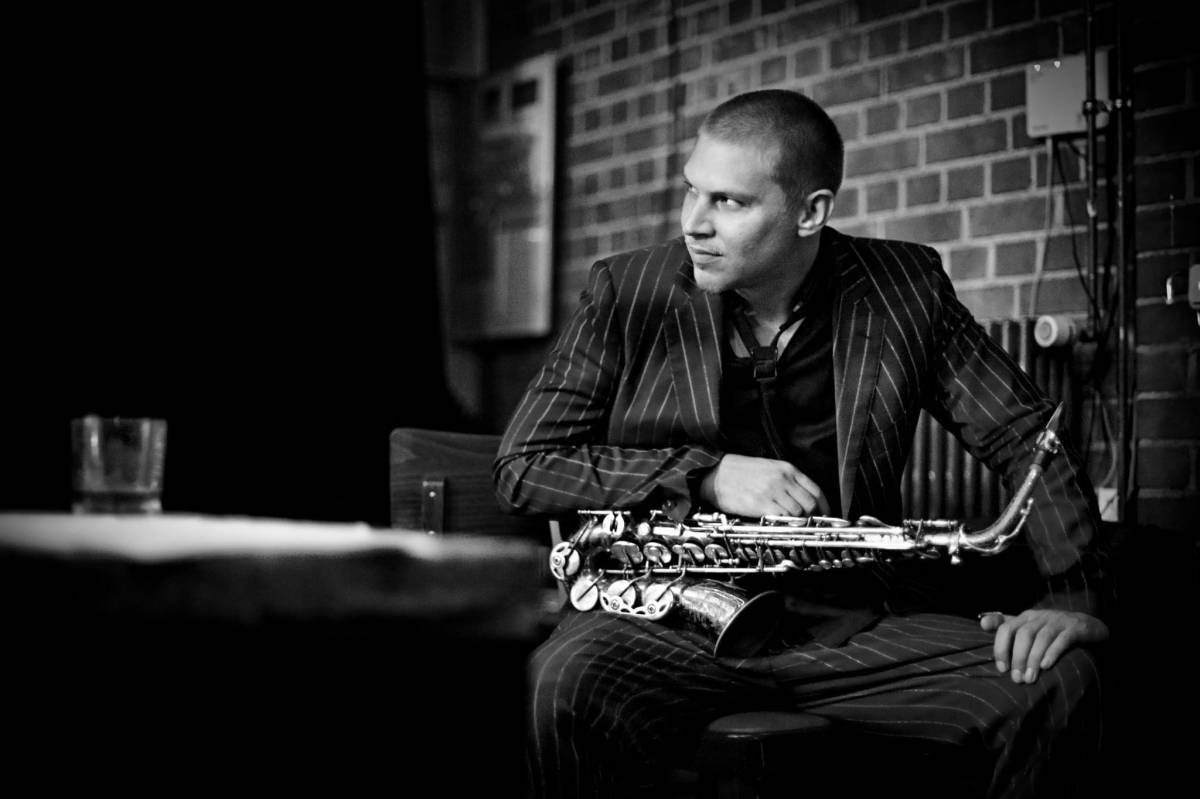136995 Black and white photo of man holding saxophone